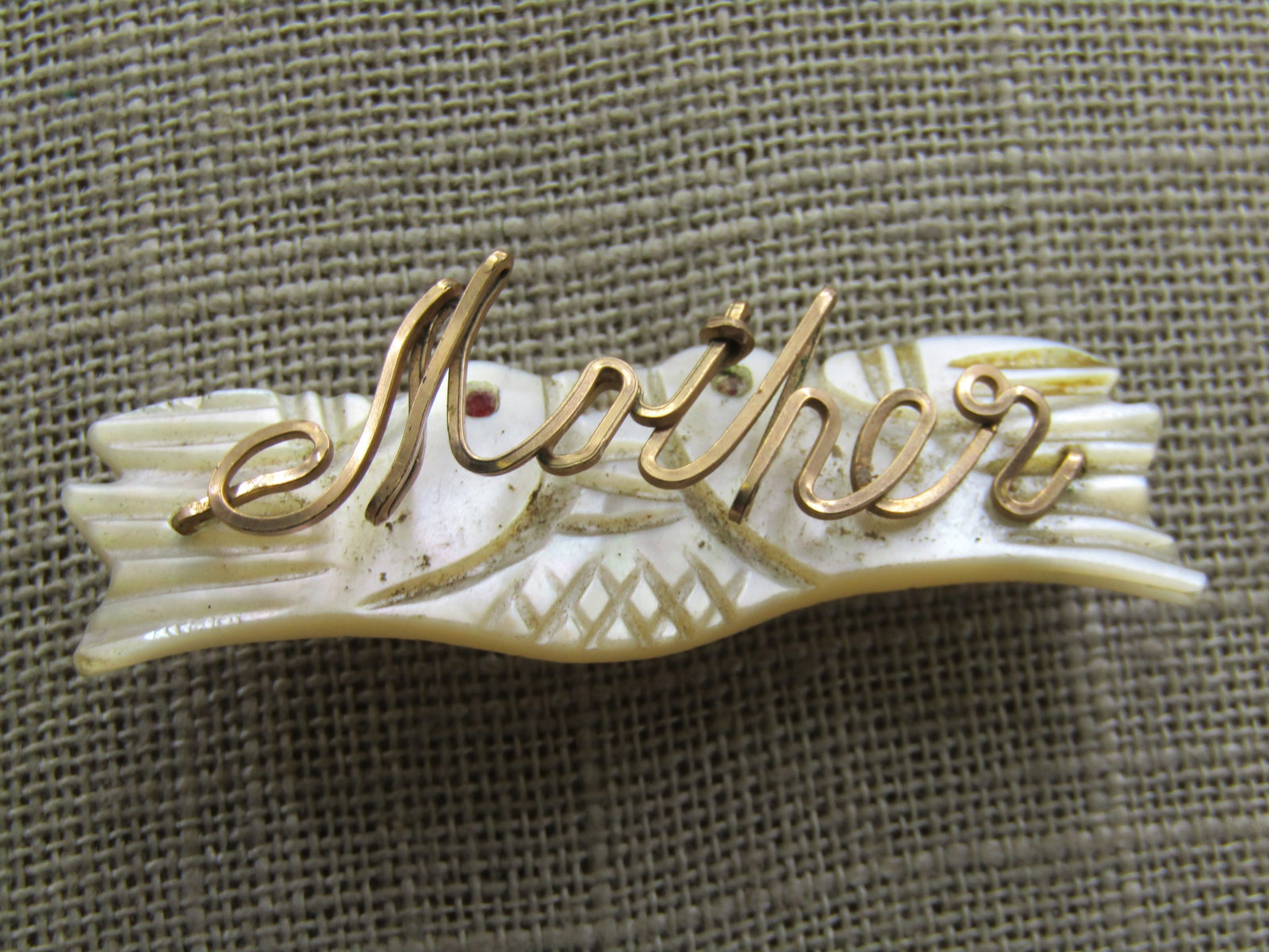 Vintage Mother-of-Pearl Doves Mother Brooch. Hand-Made: Vintage Mother-of-Pearl Doves Mother Brooch. Hand-Made, 2" by 5/8" made with 10kt G.F square wire. The doves have carved details and each has a red enameled eye - they gace eachother. Age is 1940's-19