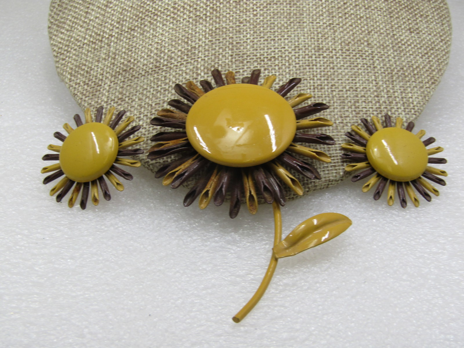 Vintage Enameled Brown and Dijon Floral Brooch Earrings Set: Vintage Enameled Brown & Dijon Sunflower Brooch Earrings Set. The brooch is 4.25" tall with curved stem and leaf and 2.5" wide. Matching earrings that are just the blossom and are 1.5" wide. The