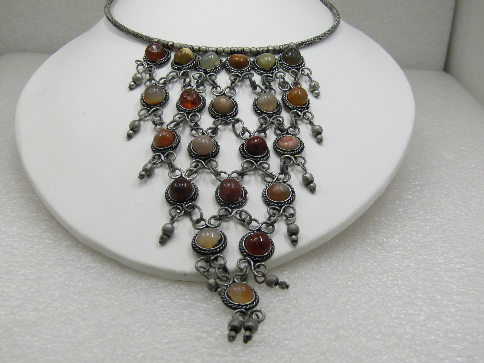 Vintage Coiled Collar Bib Necklace, 17", Stone 5" Drop: Vintage Coiled Collar Bib Necklace, 17", Stone 5" Drop with a mix of earthtone colored stones set in a rope accent frame with six stones at top tapered to a point with one stone at the bottom, silver