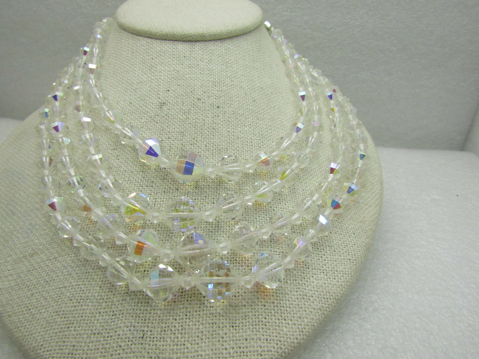 Vintage 4 Strand Aurora Borealist Crystal Necklace, 16": Vintage 4 Strand Aurora Borealist Crystal Necklace, 16" including extender chain , ornate silver tone rhinestone end caps. Beads are graduated from 6.5mm to 11mm with smaller diamond shaped spacer
