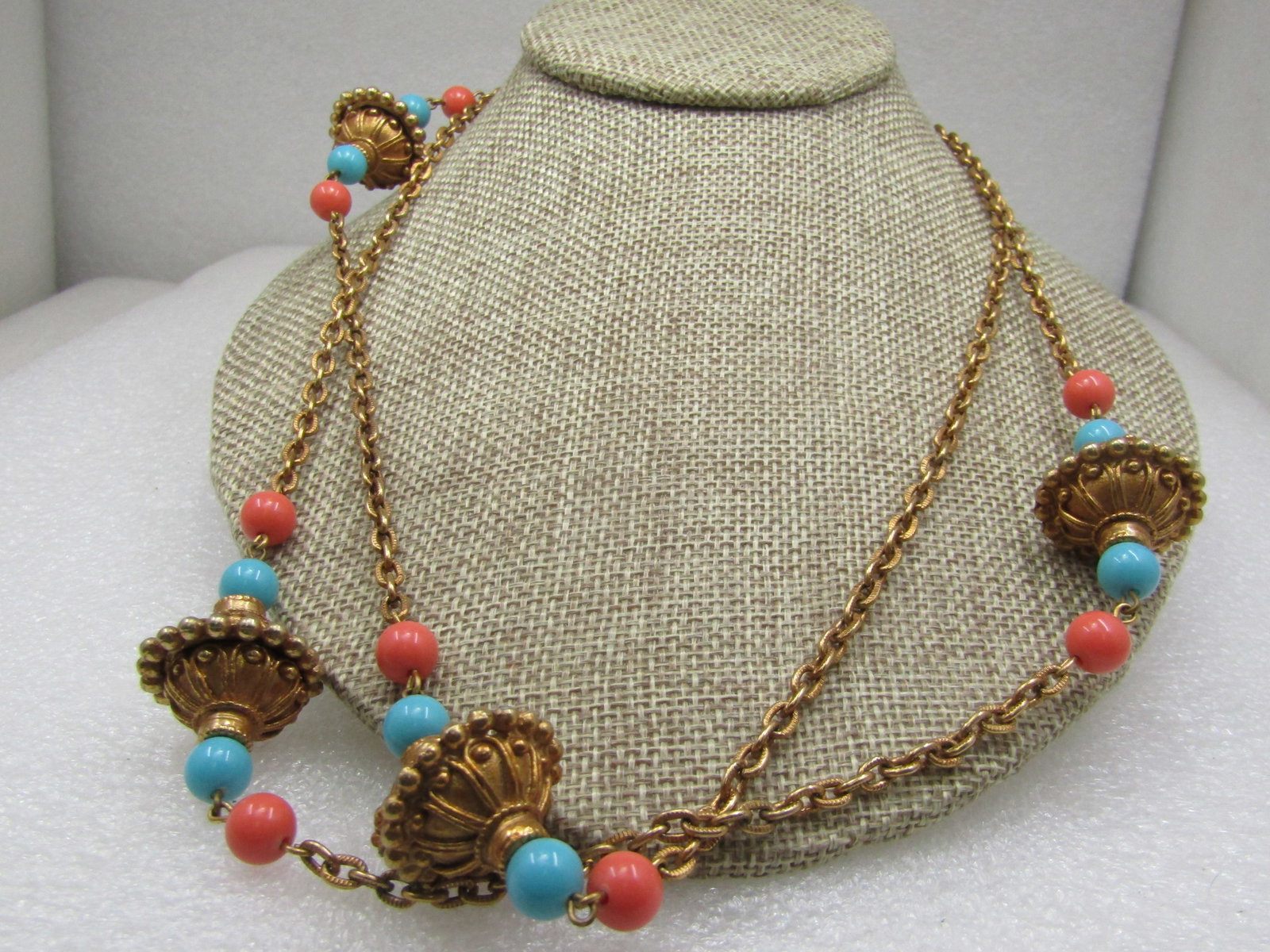 Vintage Etruscan Gold Tone Necklace, Coral and Blue Beads, 42": Vintage Etruscan Gold Tone Necklace, Coral & Blue Beads, 42". Four chunky etruscan vessel-like beads with ornate scrolling and beaded accents in gold tone metal and a turquoise blue and coral beaded o