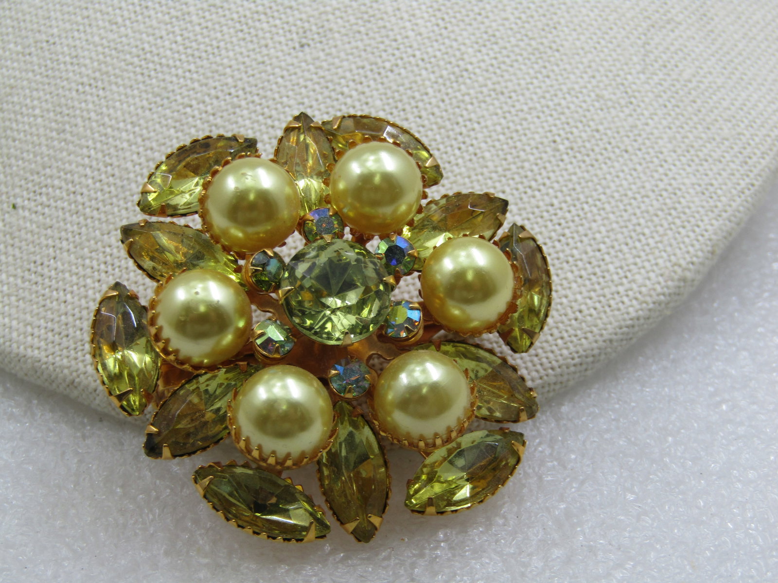 Vintage Yellow and Green Faux Pearl and Rhinestone Statement Brooch: Vintage Yellow & Green Faux Pearl & Rhinestone Statement Brooch. Gold tone, 2" with yellow, appx. 13mm long marquise stones set with prongs and a sawtooth bezel. Next is a tiered layer of yellow shimm