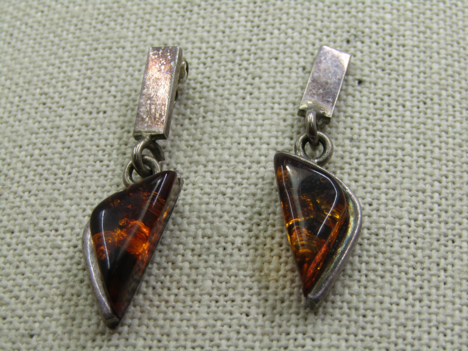 Vintage Sterling Amber Drop ModernistEarrings, 1.5",: Vintage Sterling Amber Drop Modernist Earrings, 1.5" long and slightly under 1/2" wide at the widest point. 1960's or slightly thereafter. A boder design with a bar stud from which a triangular