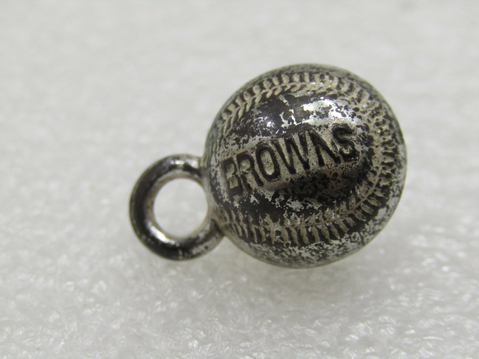 Vintage Baseball Charm/Pendant, Browns, Silver Tone, Mid-Century: Vintage Baseball Charm/Pendant, Browns, Silver Tone, believed to be a Cracker Jack Toy, Mid-Century. It is appx. 3/4" long with the ring on top. Silver tone metal with stitches and Browns imprinted in