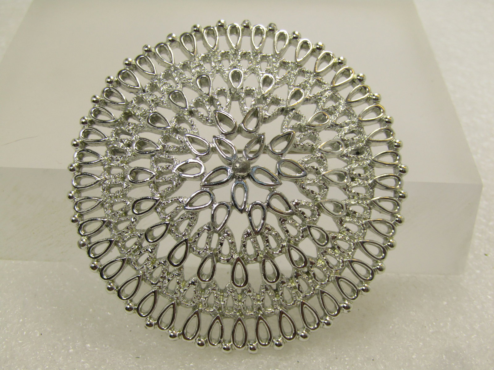 Vintage Large Medallion Domed Brooch, Sarah Cov., 1970's: Vintage Large Medallion Domed Brooch, Sarah Cov., 1970's. This is silver tone with a filigree like openw ork design with smooth and textured finish. It is appx. 2.5". Very clean and in very good condi