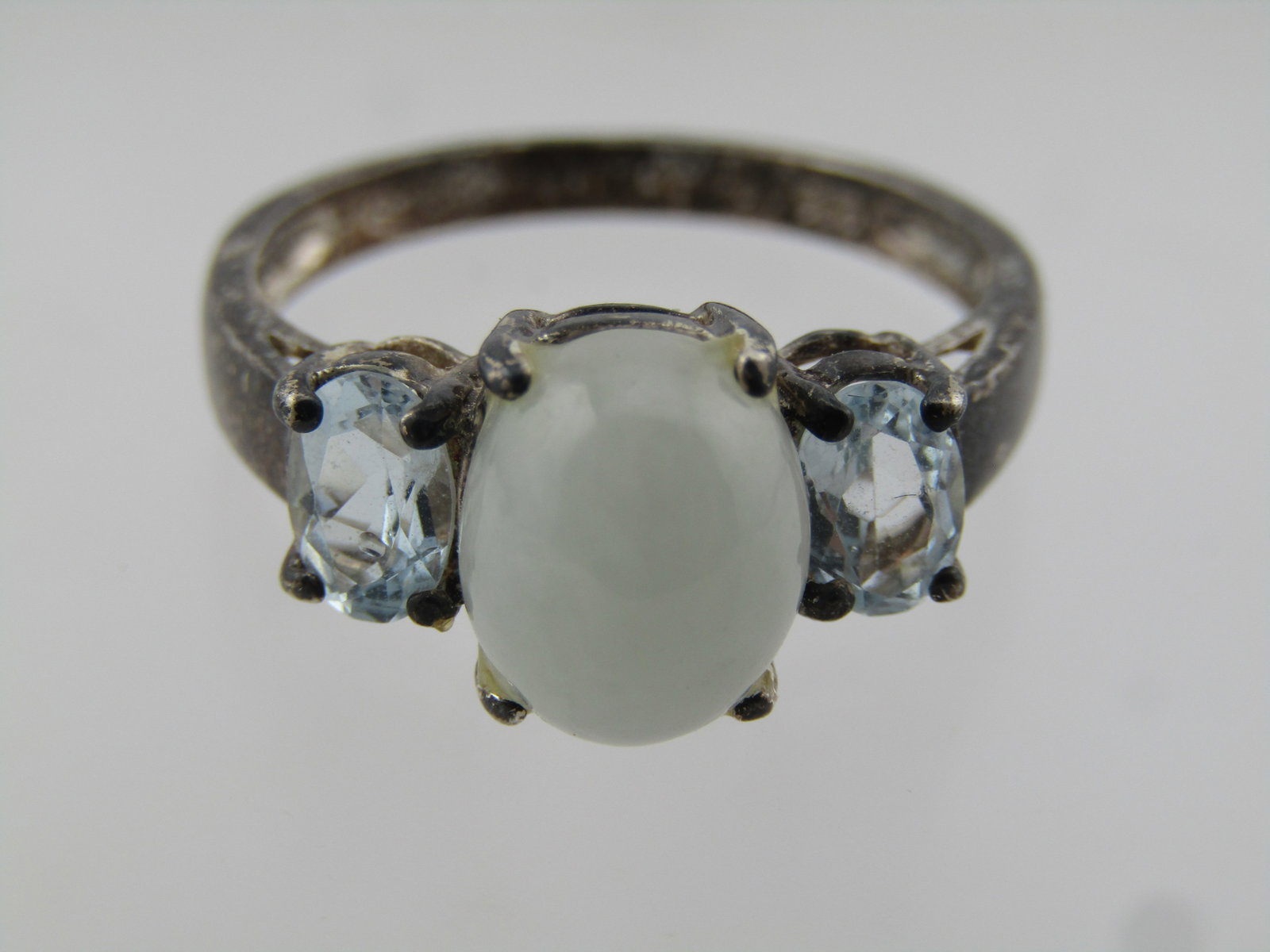 Vintage Sterling Jade and Blue Topaz Ring, Avon, Sz. 925. 1980's: Vintage Sterling Jade and Blue Topaz Ring, Avon, Sz. 925. 1980's. This is marked .925 and tests as sterling with a weight of appx. 3.6 grams. It has a center domed oval cabochon of jadeite. That is