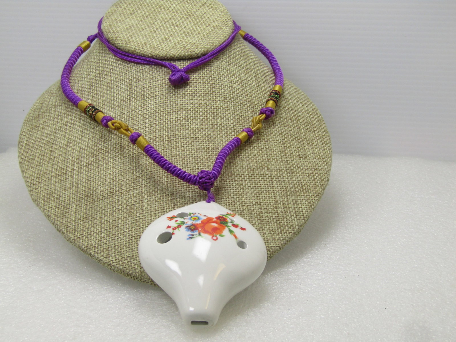 Vintage Handmade Ceramic Ocarina Macrame Necklace, 28", Adjustable Length, 1980's: Vintage Handmade Ceramic Ocarina Macrame Necklace, 28", Adjustable Length, 1980's. White ceramic ocarina with floral fired on and glazed ocarina. The ocarina is appx. 3.25" tall and 2.25" wide. The ne