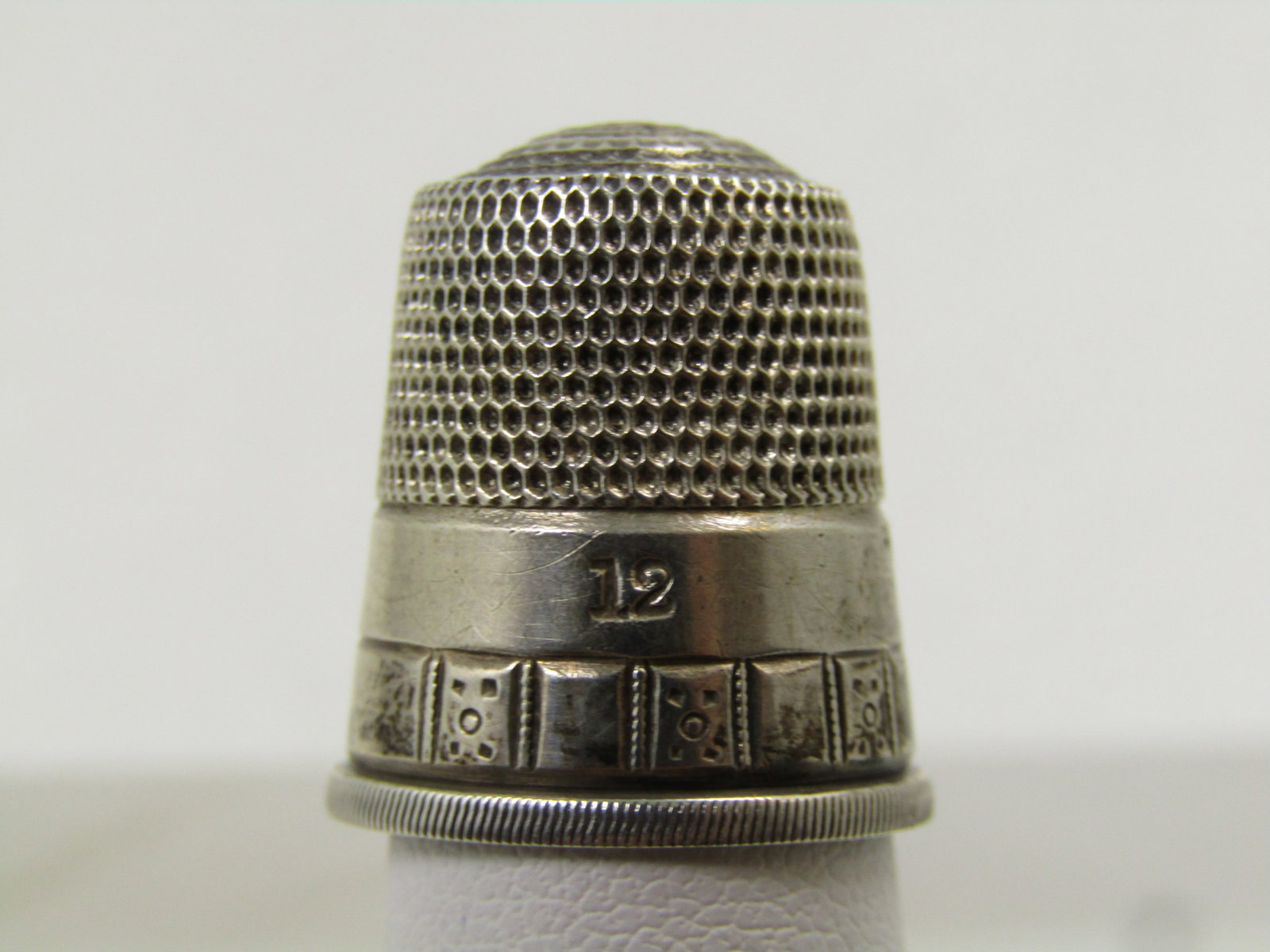 Vintage Sterling Thimble, Sz. 12, Signed, 1930's-1950's: Vintage Sterling Thimble, SZ 12. Signed. Etched trim with a plain band above that with the size 12 marked on the plain band above the decorative edge band - inside there is a face or sun like marking