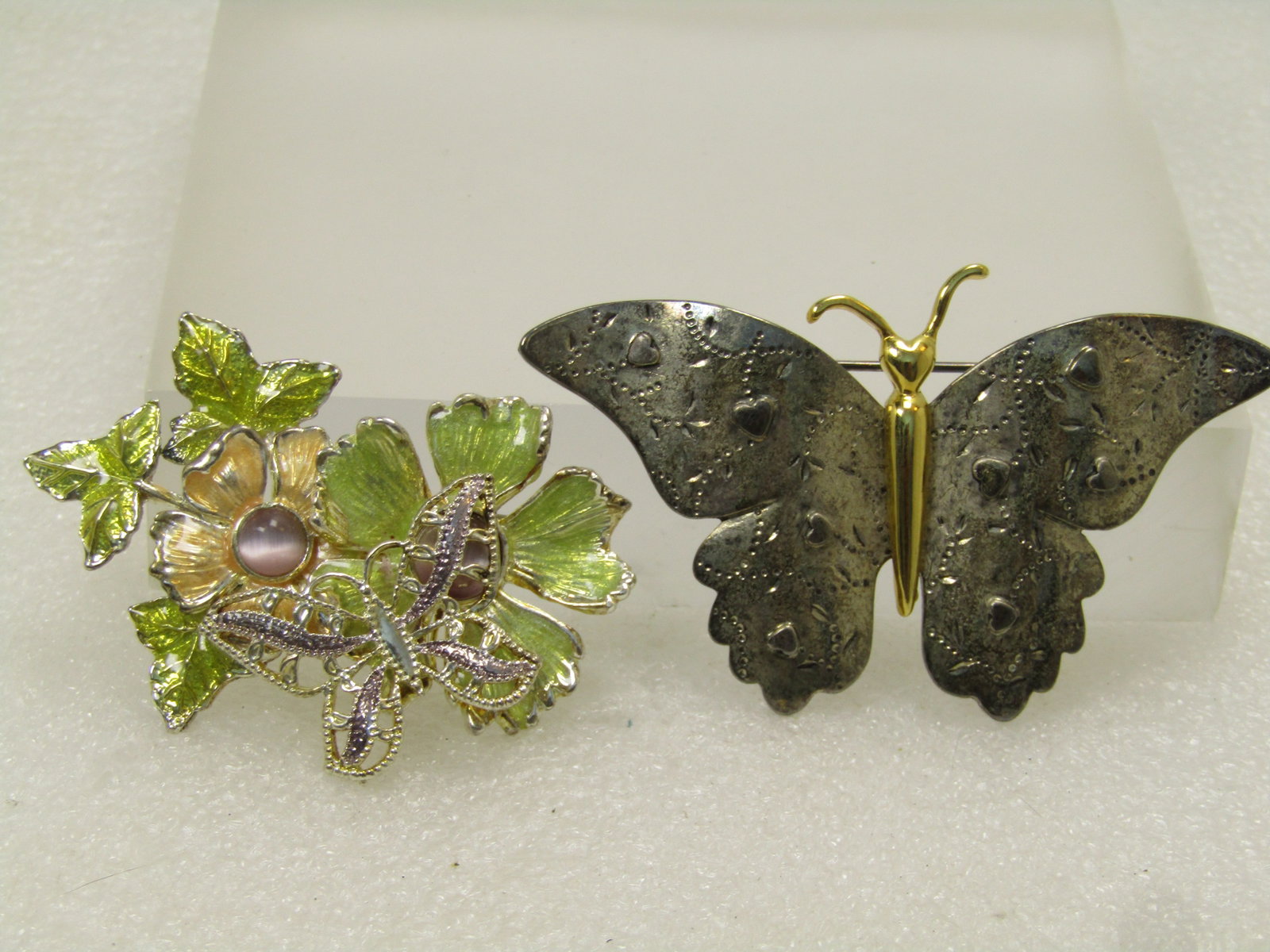 Vintage Butterfly and Floral Brooch Lot, 2 Pc. 1970's-1990's: Vintage Butterfly and Floral Brooch Lot, 2 Pc. 1970's-1990's. the 1970's one is a silver tone winged butterfly with raised hearts on the wings and a gold tone head/torso/antenna. It is appx. 2.75" wid
