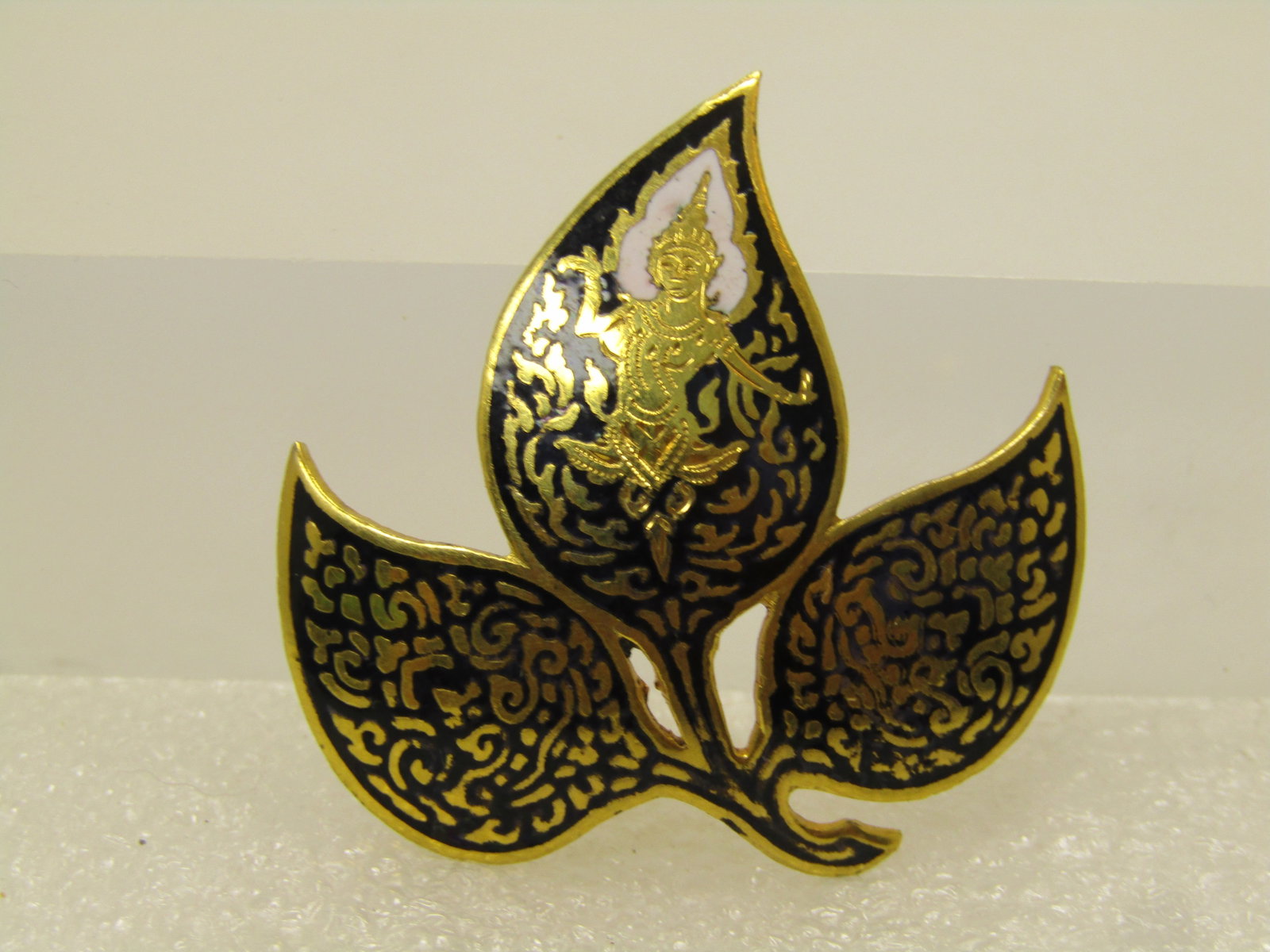 Vintage Siam Goddess Leaf Brooch, 1960's, C-Clasp: Vintage Siam Goddess Leaf Brooch, 1960's, C-Clasp. Gold ton domed leaf with black enameled bckground and raised gold tone accents with a goddess with white enameled flames behing the head. The brooch 