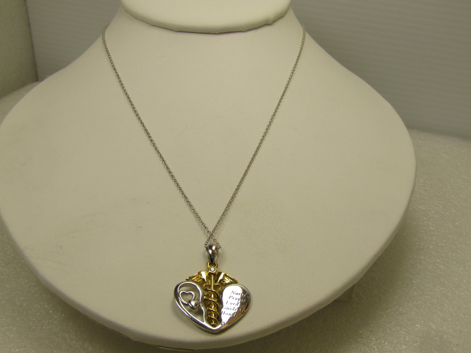 Sterling Nurse's Prayer Heart Necklace, 19", 1980's-1990's: Sterling Nurse's Prayer Heart Necklace, 19", 1980's-1990's. This a sterling heart with heart accents in the heart as well as a gold tone medical symbol in the center and the Nurse's prayer which