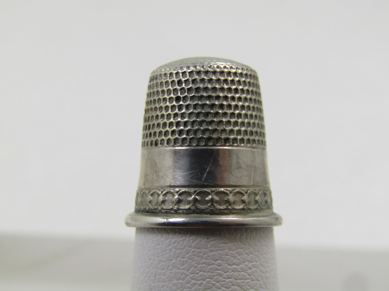 Vintage Sterling Thimble, Sz. 8 , 1920's-1940's: Vintage Sterling Thimble, Sz. 8 , 1920's-1940's. This has a rolled base to keep the opening's shape with a raised design above the rolled band and then a smooth band where it is marked with the size