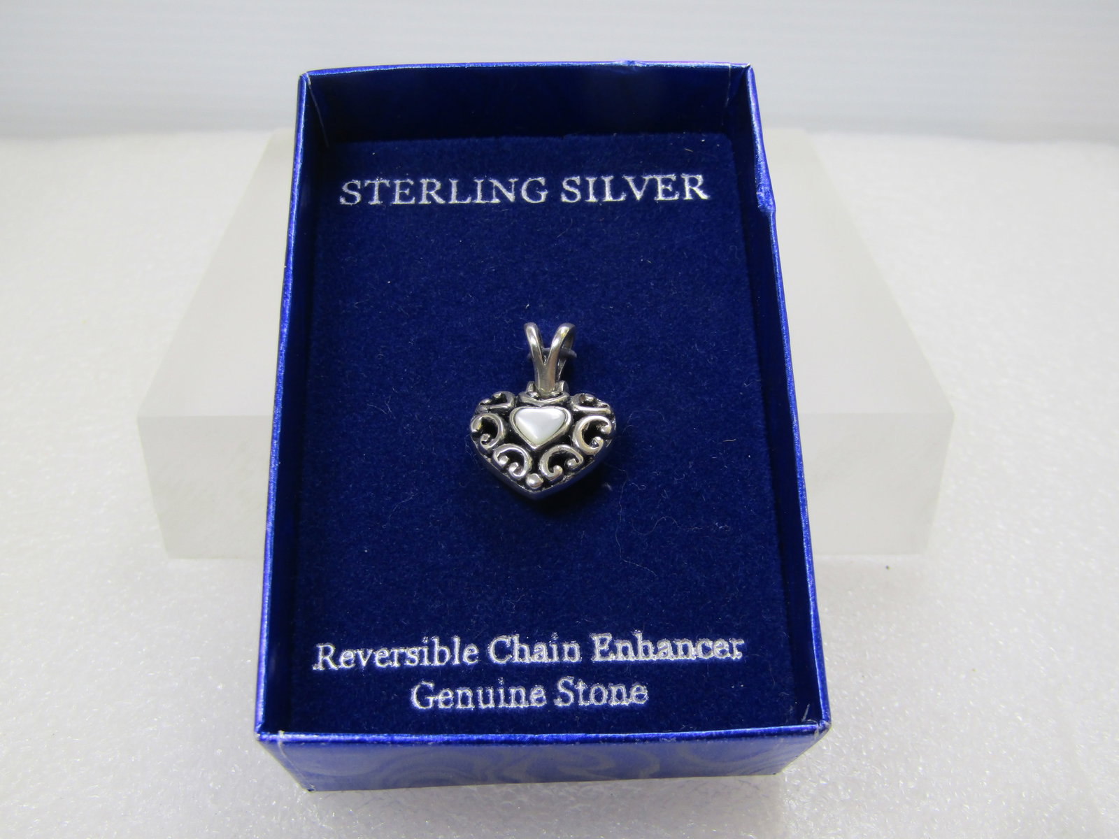 Vintage Sterling Reversible Heart Pendant, Onyx and MOP, In Original Box, 1990's: Vintage Sterling Reversible Heart Pendant, Onyx and MOP, In Original Box, 1990's or slightly after. The pendant is puffy and scrolled - heart shaped with a mother-of-pearl heart on one side and black 