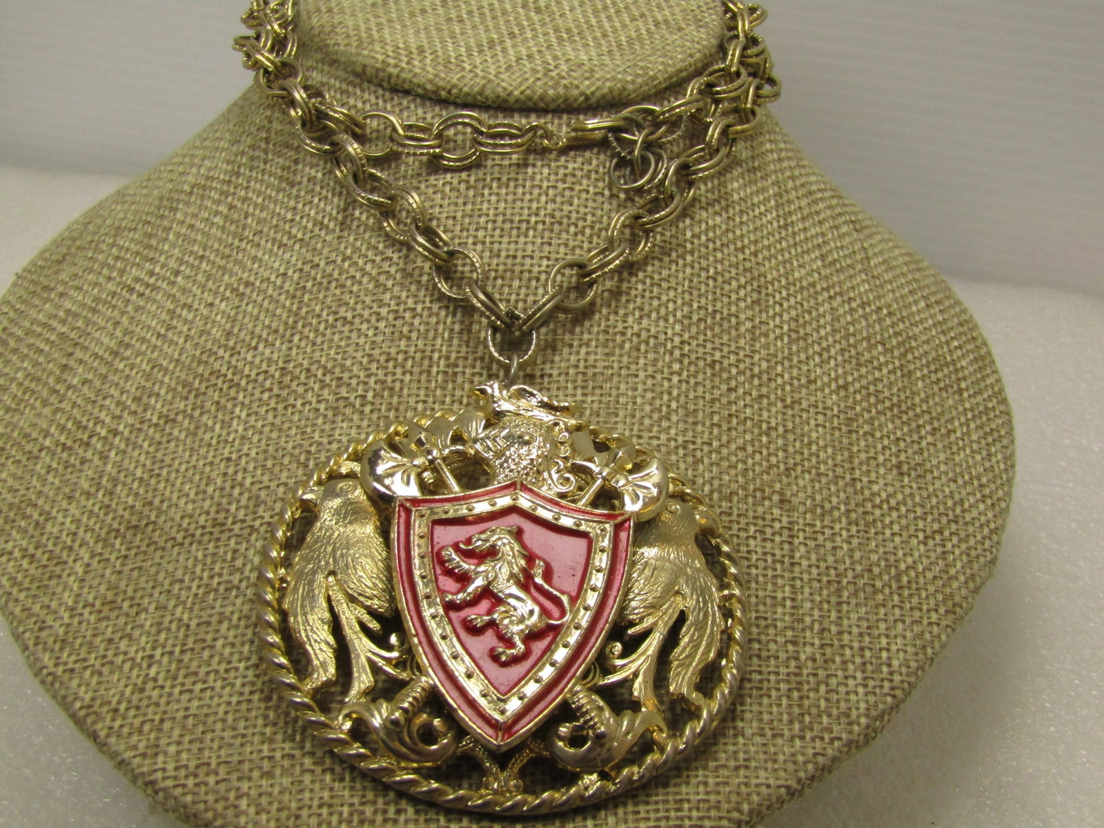 Vintage Enameled Lion Shield Medallion Necklace, 24", 2.5" 1960's-1970's: Vintage Enameled Lion Shield Medallion Necklace, 24", 2.5" 1960's-1970's. Medallion style pendant with raised lion shield with crossed long axes and a knight's helmet with a bird on top and on the