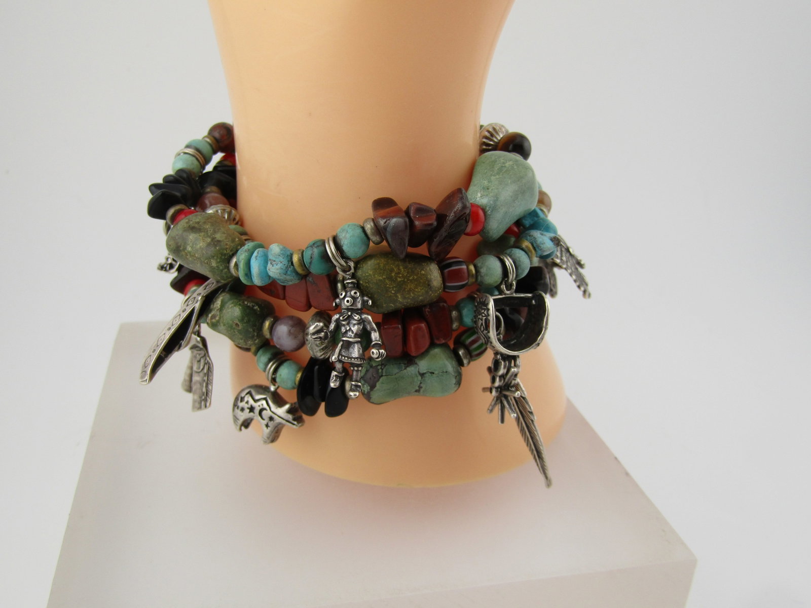 Vintage Sterling Southwestern Four Strand Bracelet, Turquoise and Other Stones, 1990's: Vintage Sterling Southwestern Four Strand Bracelet, Turquoise and Other Stones, 1990's. 7" with sterling and non-sterling charms. This has an Native American headdress; styrup; feather; bear; canoe; d