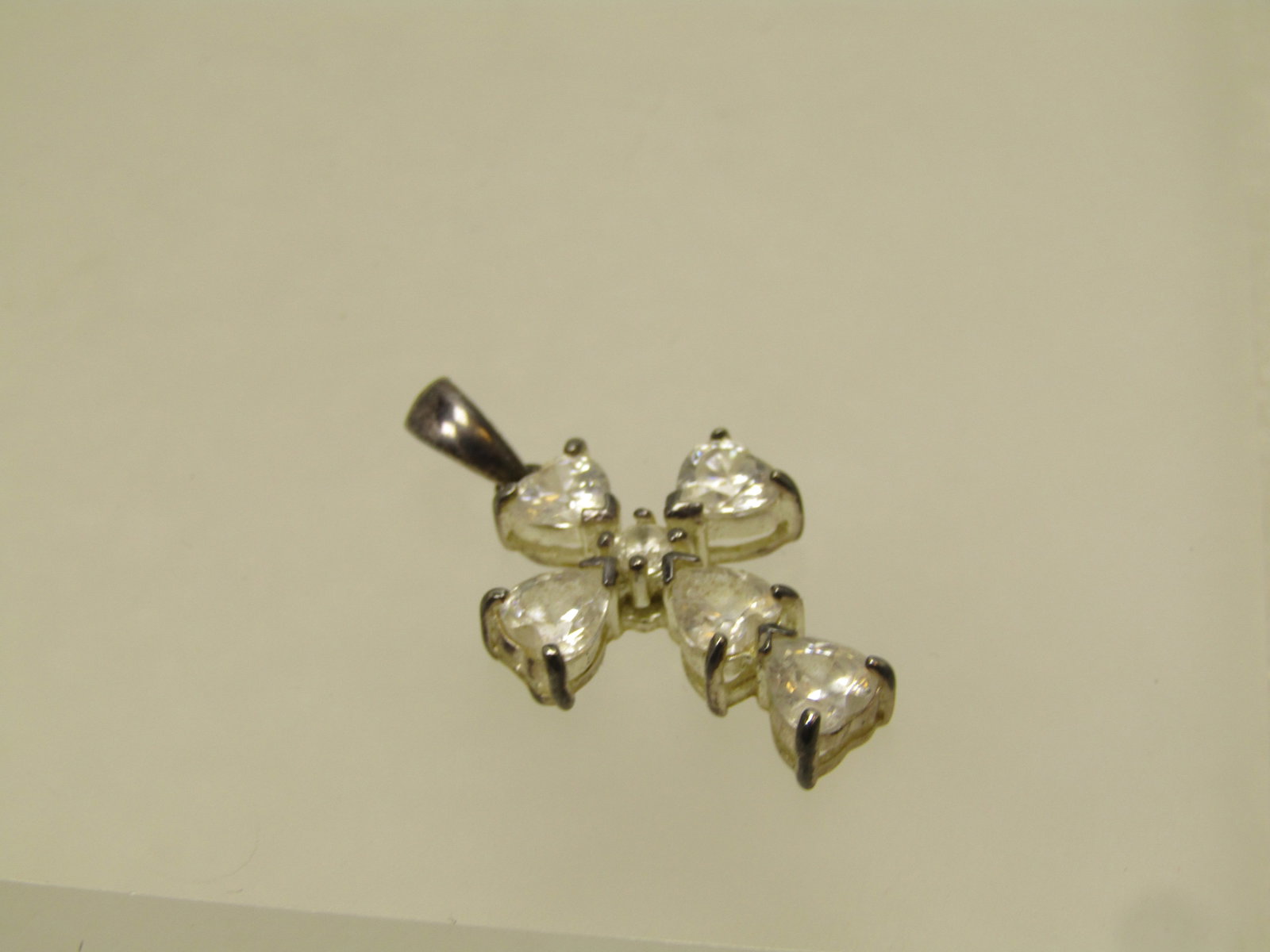 Vintage Sterling CZ Heart Cross Pendant, 1980's-1990's: Vintage Sterling CZ Heart Cross Pendant, 1980's-1990's. The pendant has clear crystal stones that make up the corss, except the center stone is round. The cross has a swing bail and is appx. 1-1/8" ta