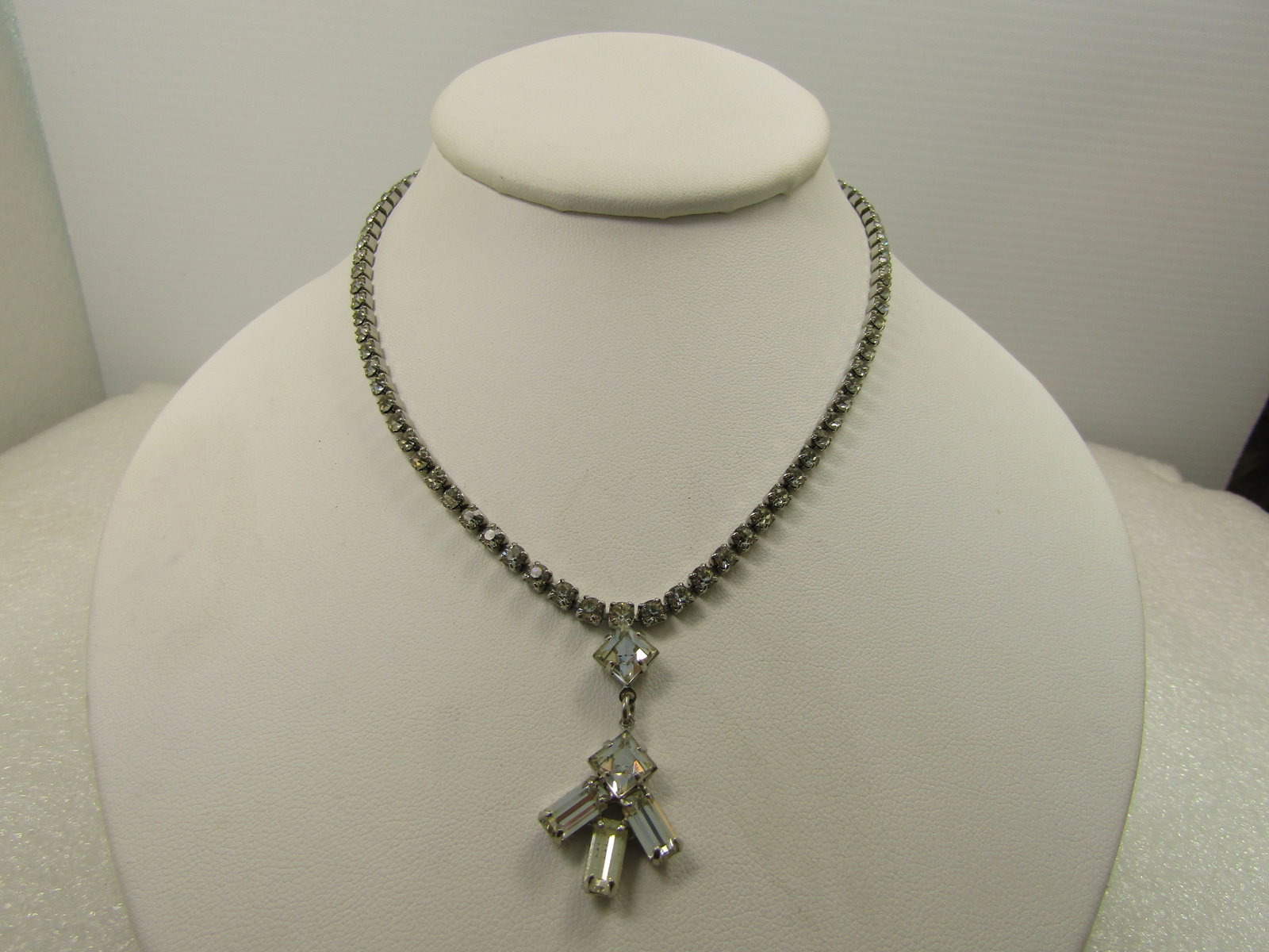 Vintage All Rhinestone Drop Necklace, 1960's. 15": Vintage All Rhinestone Drop Necklace, 1960's. 15". All round clear rhinestones - bright and clear and even in color, set in closed back square or rectangular settings with a flip clasp. The drop is a 