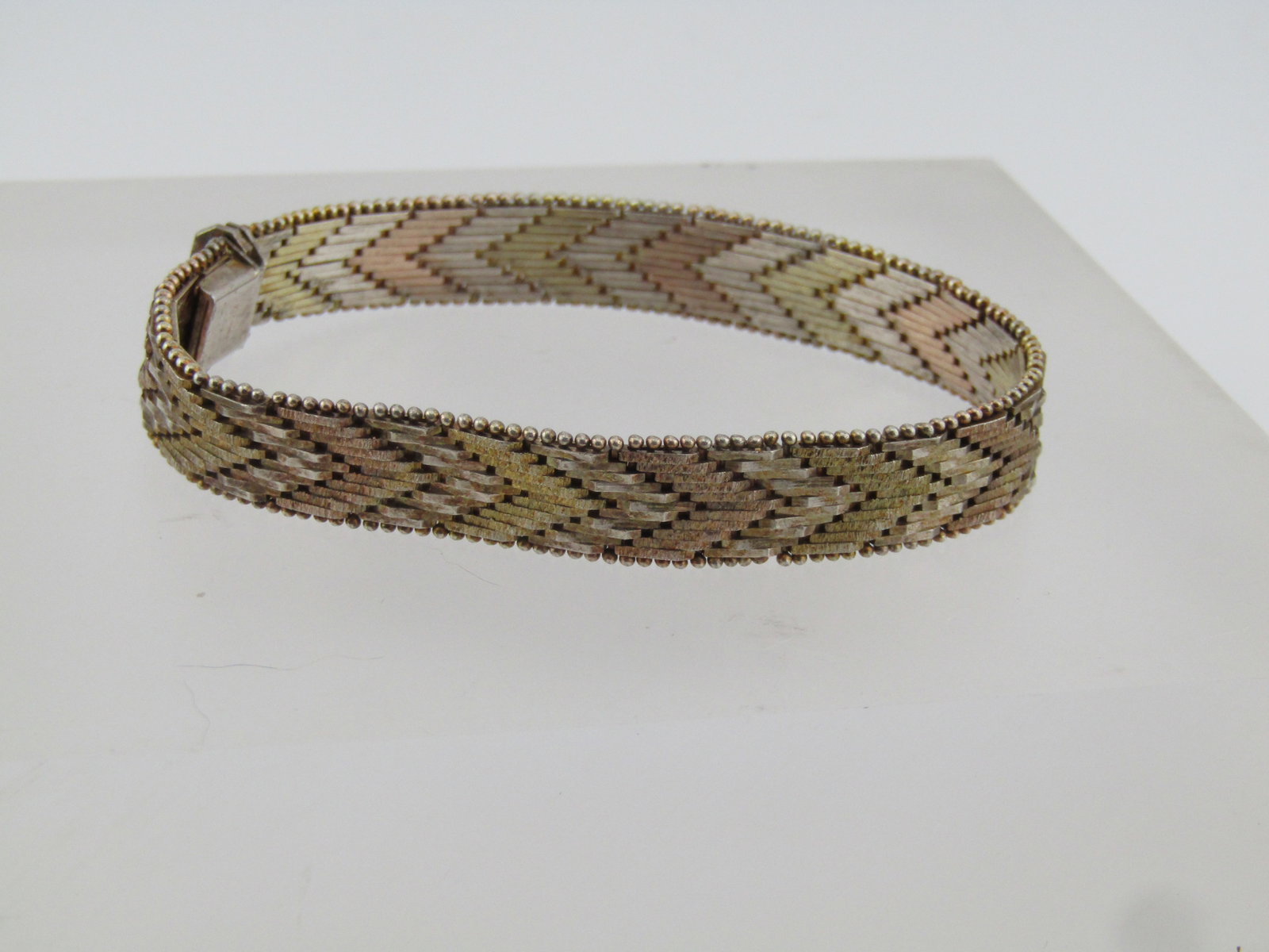 Vintage Sterling Tri-Color Woven Bracelet, 7", 1980's-1990's: Vintage Sterling Tri-Color Woven Bracelet, 7", 1980's-1990's. The bracelet is marked .925 and Italy and tests as sterling with an appx. weight of 22.70 grams. It is appx. 10mm wide with a locking box 