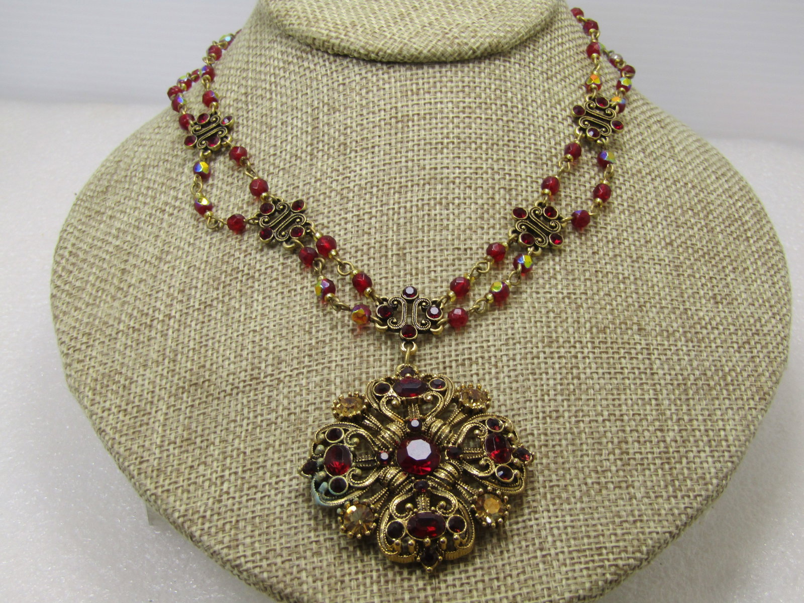 Vintage Avon Red Crystal Festoon Necklace, Signed Nina Ricci, 1980's: Vintage Avon Red Crystal Festoon Necklace, Signed Nina Ricci, 1980's - gred glass or crystal rhinestones and beads with aurora borealis shimmer. The pendnat is an open design with a large center