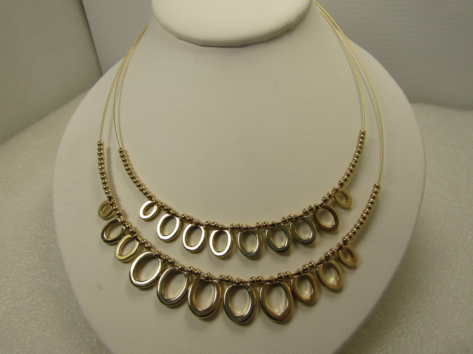 Double Strand Oval Drop Necklace, 16"-19", 1990's: Double Strand Oval Drop Necklace, 16"-19", 1990's. Gold tone graduated oval link drop necklace with round beads as well. The oval beads range from 7.5mm to 14mm long and while they look like ovals -