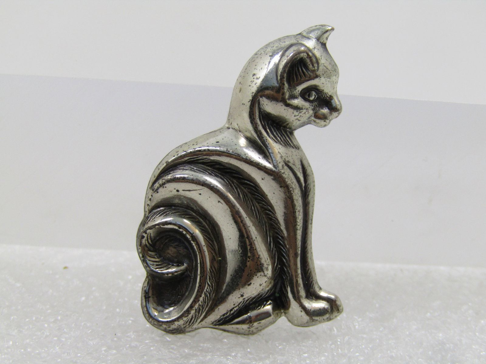 Vintage Sterling Sitting Cat Brooch, Signed Beau Sterling. 1960's-1980's: Vintage Sterling Sitting Cat Brooch, Signed Beau Sterling. 1960's-1980's. This is a pressed sterling sitting cat brooch with coiled tail and raised areas and lower areas to give great detail to this c