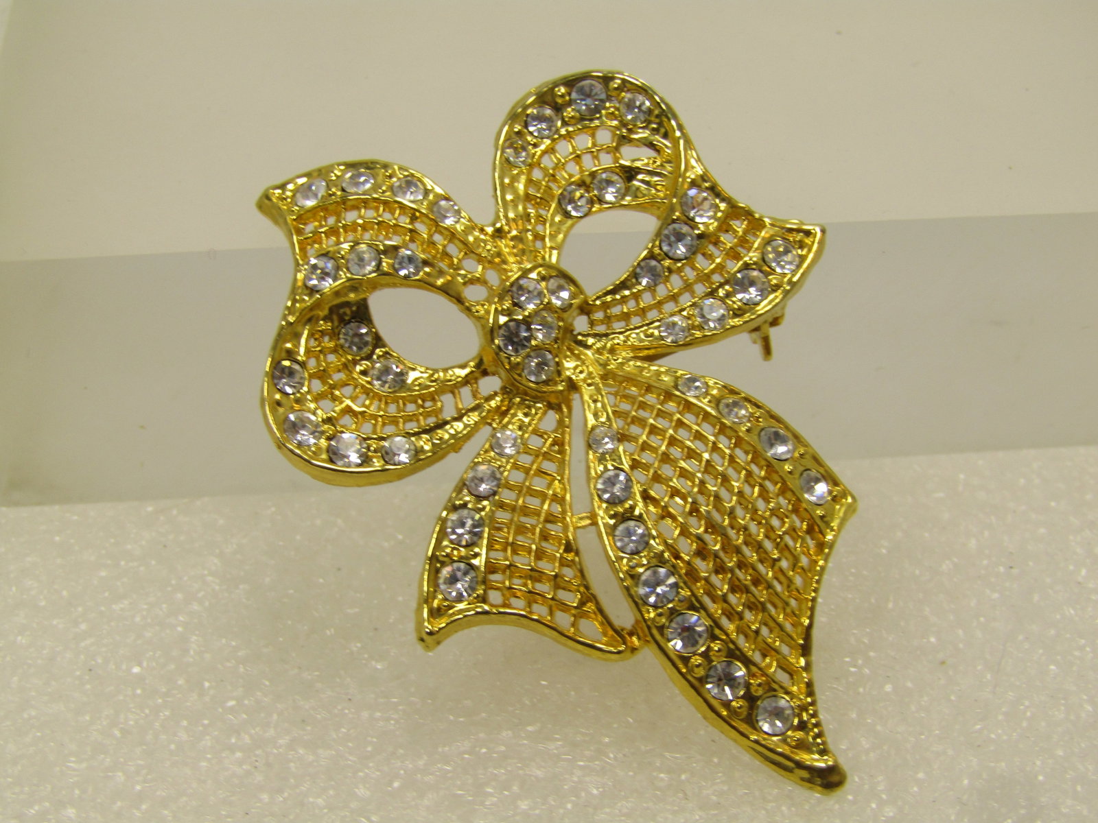 Vintage Faux Pearl Clear Rhinestone Star Brooch, 1960's-1970's: Vintage Faux Pearl Clear Rhinestone Star Brooch, 1960's-1970's. Silver tone star with clear rhinestones set in the open points and one in the center of the open points that is larger than the rest wit