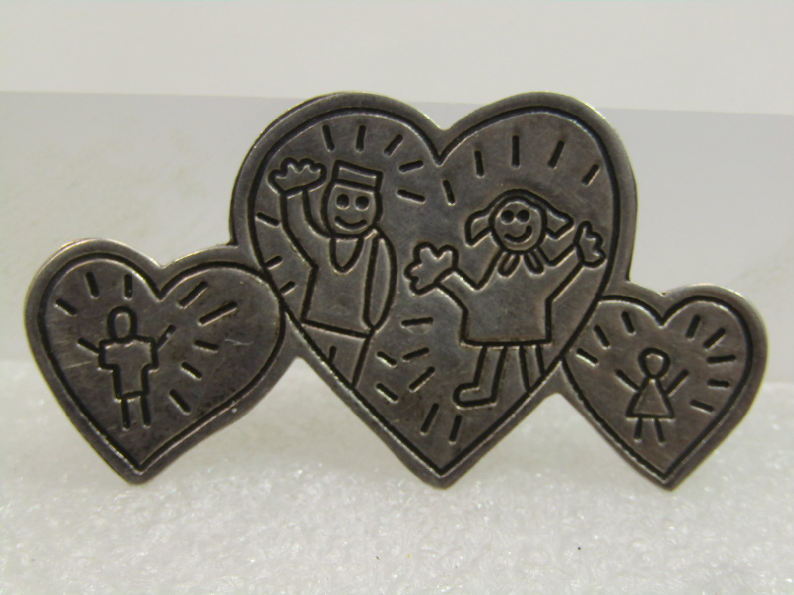Vintage Sterling Family Hearts Brooch, Mexico, 1992, Signed: Vintage Sterling Family Hearts Brooch, Mexico, 1992, Signed EFS and marked .925 and Mexico. This has a large heart in the center with one on each side with engraved parents in the center and a son on