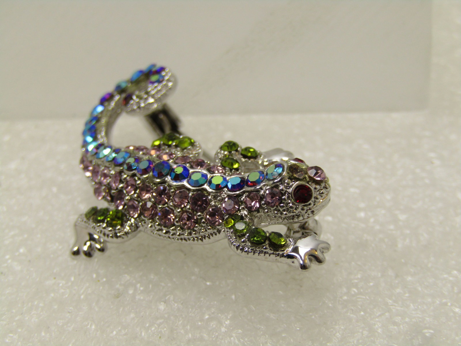 Vintage Rhinestone Lizard Brooch, Aurora Borealis, 1980's: Vintage Rhinestone Lizard Brooch, Aurora Borealis, 1980's. Mixed rhinestones in aurora borealis peacock colors, pink, green with red eyes. Silver tone - locking clasp and in very good condition. Some 