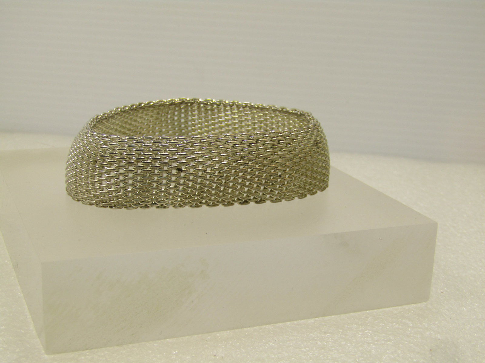 Wide Woven Silver Tone Bracelet, Slip-On 8", 1980's: Wide Woven Silver Tone Bracelet, Slip-On 8", 1980's.This is a soft bangle style bracelet. It is appx. 7/8" wide, slightly domed woven bra celet. Silver tone. It is marked .925 but doesnot test as