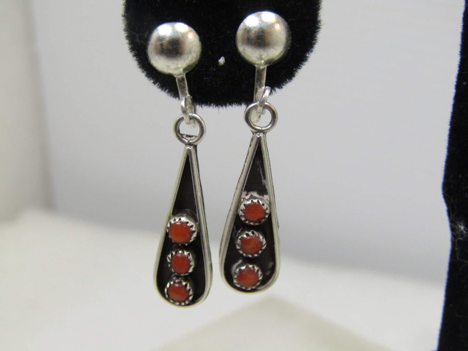 Vintage Sterling Southwestern Coral Earrings, Screwback, Snake Eyes, 1960's-1970's: Vintage Sterling Southwestern Coral Earrings, Screwback, Snake Eyes, 1960's-1970's. Zuni petit point design. Three sawtooth bezel set, appx. 2mm round red coral stones in shadow box teardrop dangle