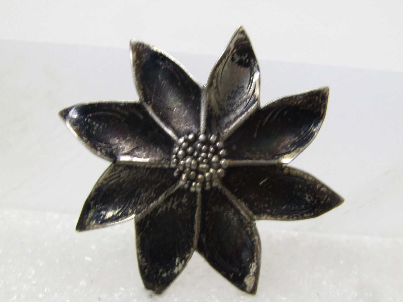 Vintage Sterling Poinsettia Brooch, Signed Nye, 1940's: Vintage Sterling Poinsettia Brooch, Signed Nye, 1940's. This is appx. 1.25" wide and riaised in the center with each petal easily defined and also with markings in the petals. This has the typical vin
