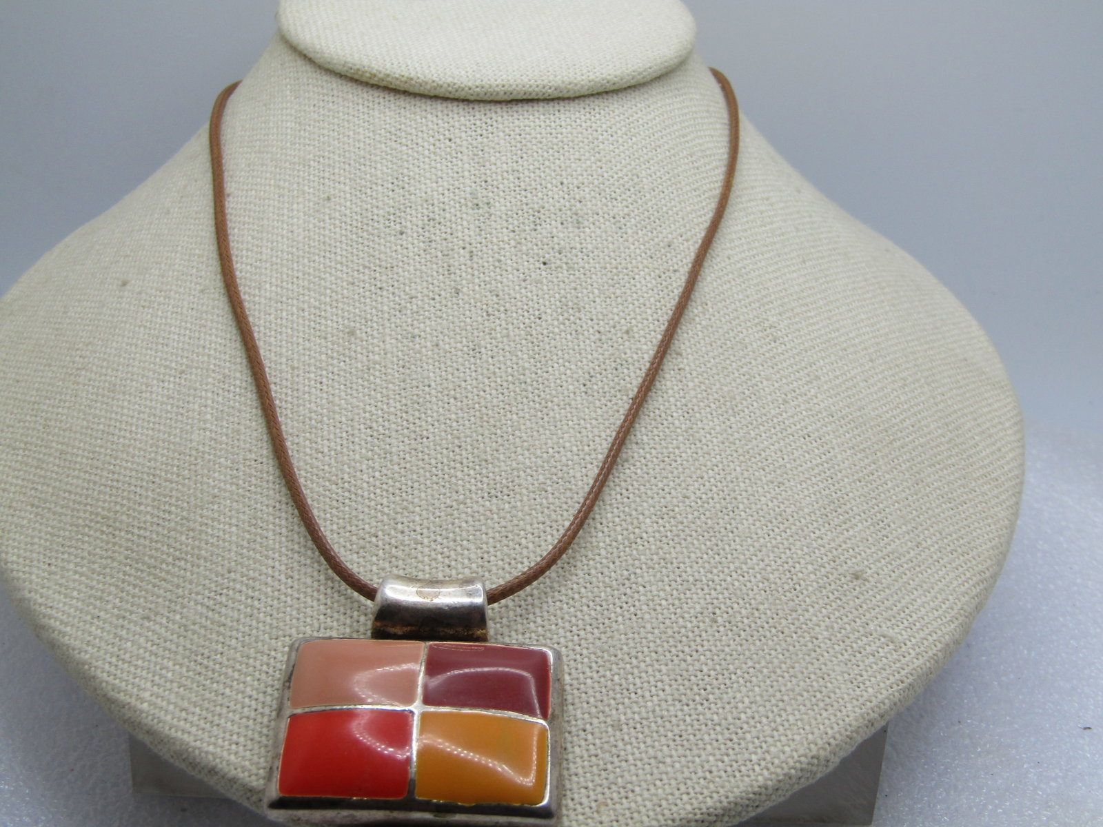 Vintage Enameled Orange and Brown Pendant Necklace, Signed MJ, 1990's: Vintage Enameled Orange and Brown Pendant Necklace, Signed MJ, 1990's. Rectangular silver tone slide with wide macaroni style bail. It is a quadrant of four colors, tan, brick, orange and golden ename