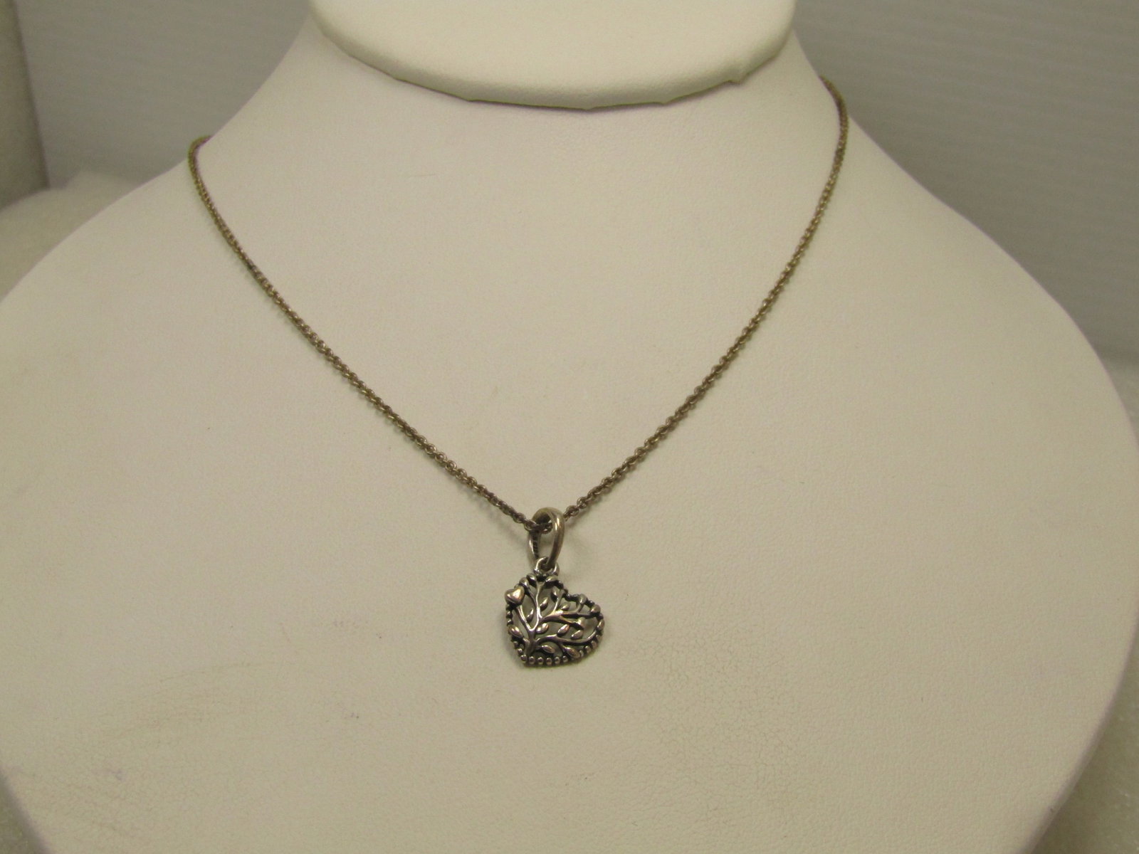 Vintage Sterling Pandora Heart Necklace, 17" 1990's: Vintage Sterling Pandora Heart Necklace, 17". 1990's. It is signed ALE (which is Pandora's mark). It is a heart shaped pendant that is slightly domed and filed with leaf and limb design. It hang from 