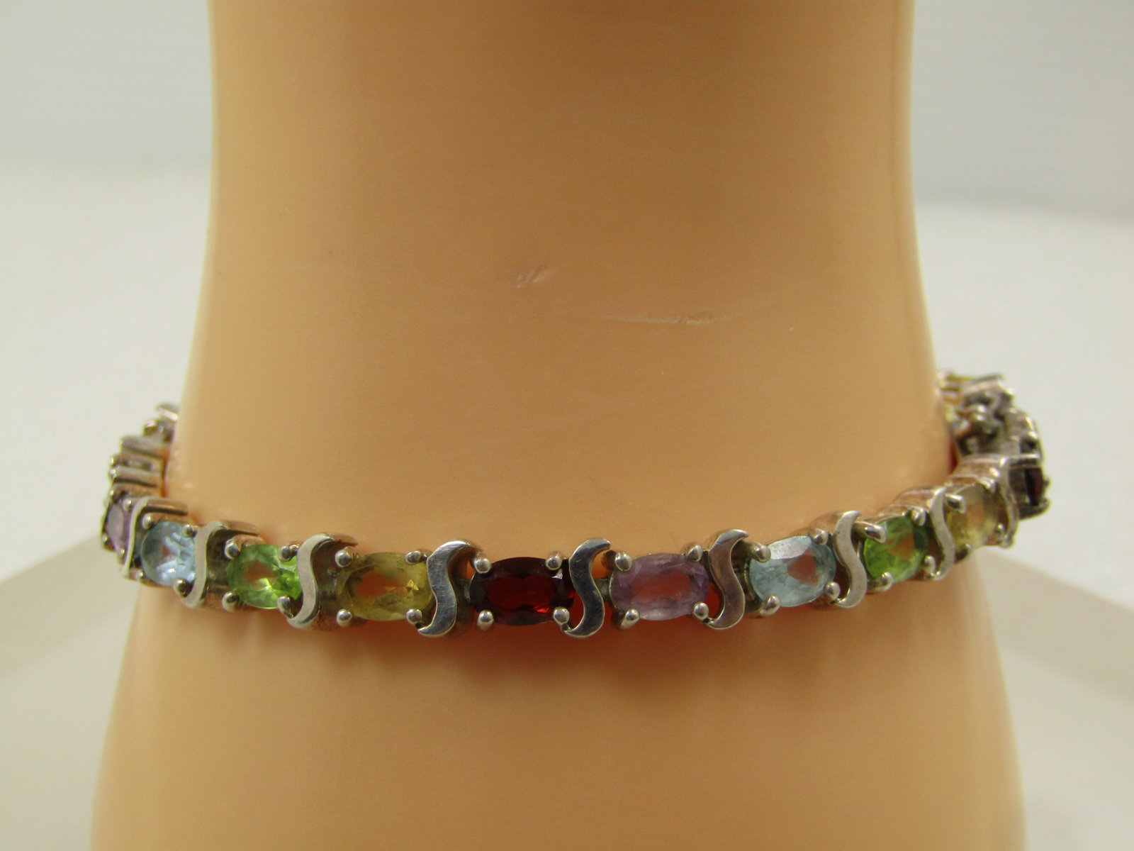 Vintage Sterling Mixed Gemstone Tennis Bracelet, 7.50", Safety Locks, Signed, 1980's: Vintage Sterling Mixed Gemstone Tennis Bracelet, 7.50", Safety Locks, Signed UP, Thailand, 1980's. This has oval semi-precious gemstones: citrine; amethyst; peridot; blue topaz; and, garnet. It has a 