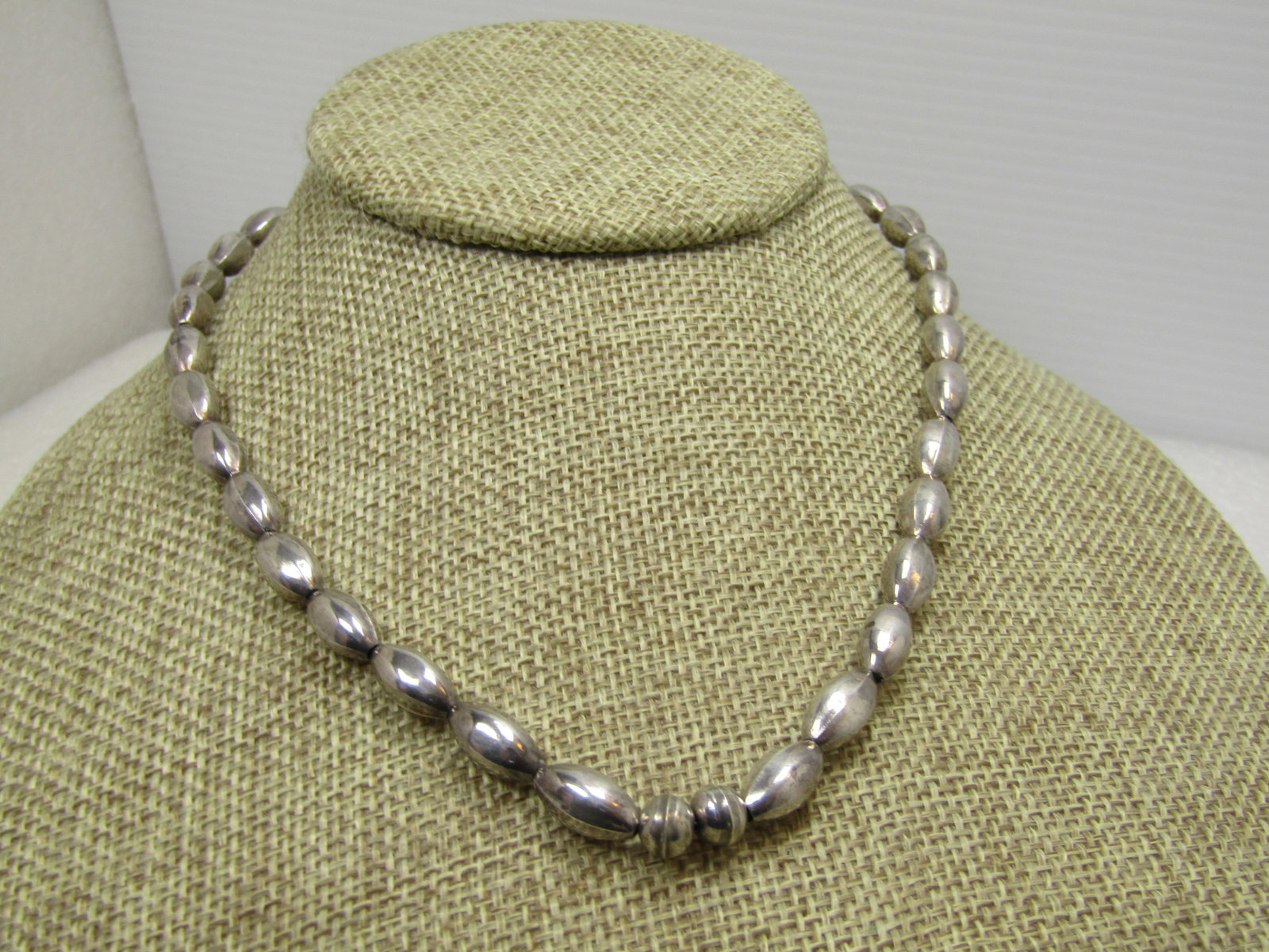Vintage Sterling Navajo Oval Pearl Beaded Necklace, 16.5", 1970's-1980's: Vintage Sterling Navajo Oval Pearl Beaded Necklace, 16.5", 1970's-1980's. This has mostly oval beads with two round beads at the center. It tests as sterling with a weight of appx. 10.41 grams. Hook