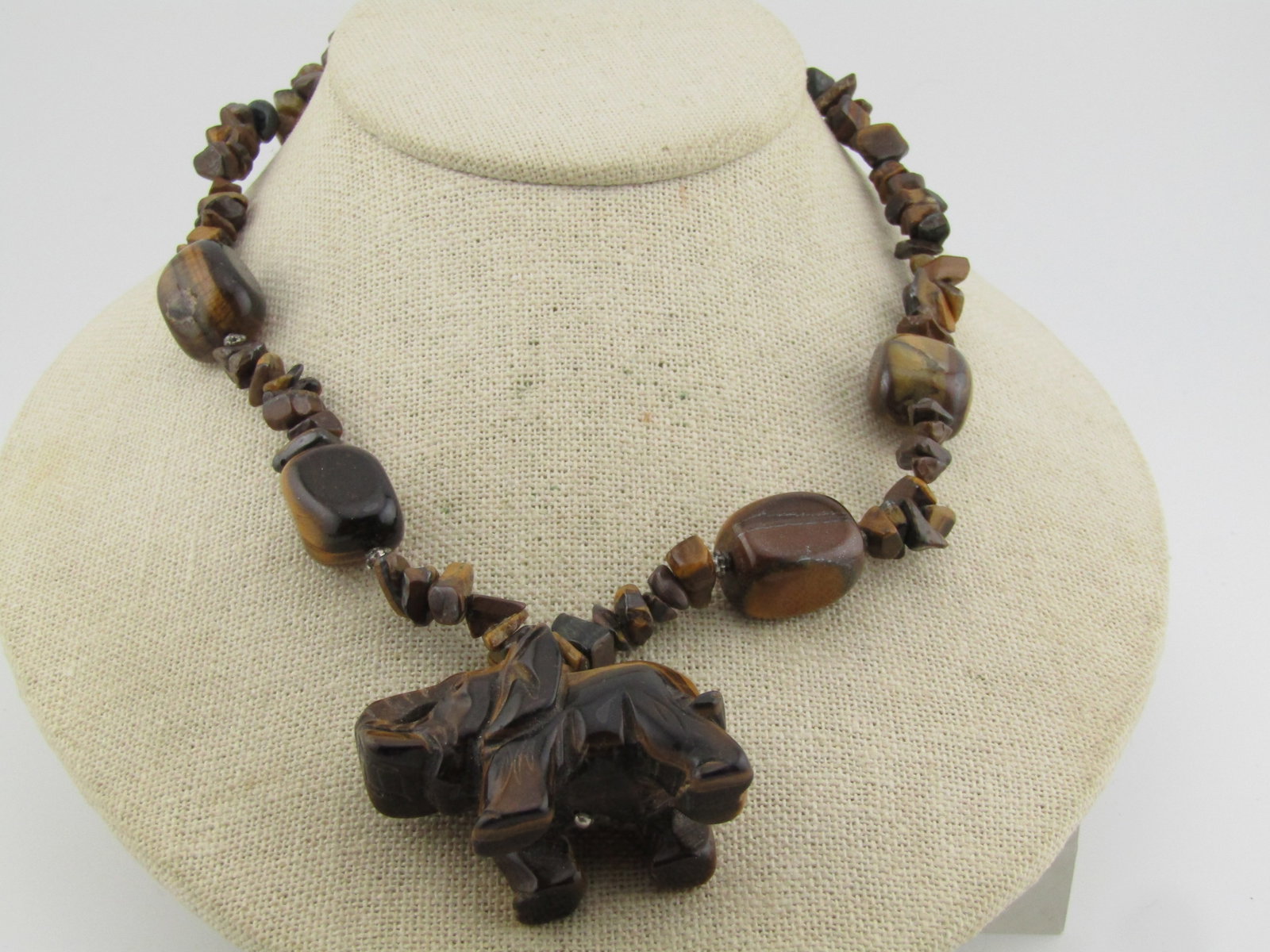 Vintage Tiger's Carved Carved Elephant Necklace, 20", 1980's-1990's: Vintage Tiger's Carved Carved Elephant Necklace, 20", 1980's-1990's. This is a total of 20" with a silver tone chain and lobster clasp included. It has a large elephant that drops down fromt he