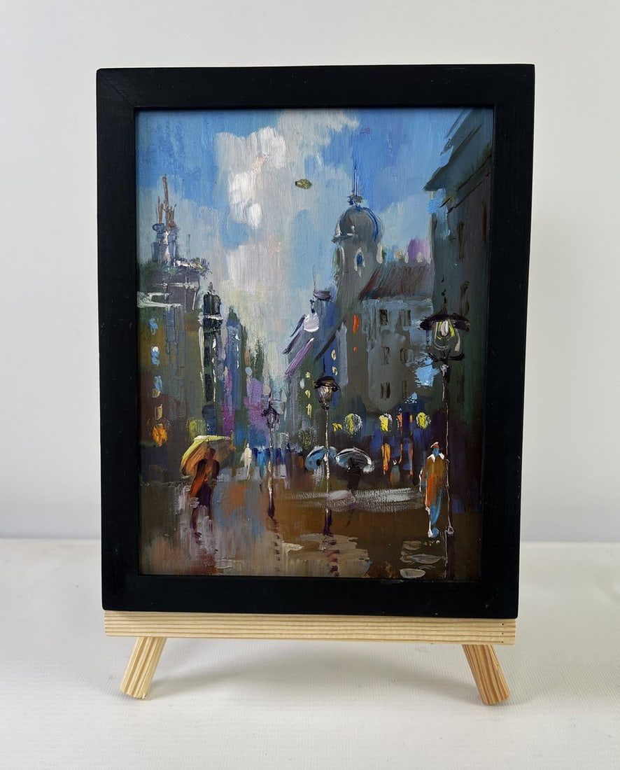 Oil painting Dynamics of the city during rain Yuriy Suprunchuk: NoAAA5515The Oil painting on Cardboard titled "Dynamics of the city during rain" captures the fleeting, almost poetic atmosphere of a city in the rain, where reflections, blurred outlines, and