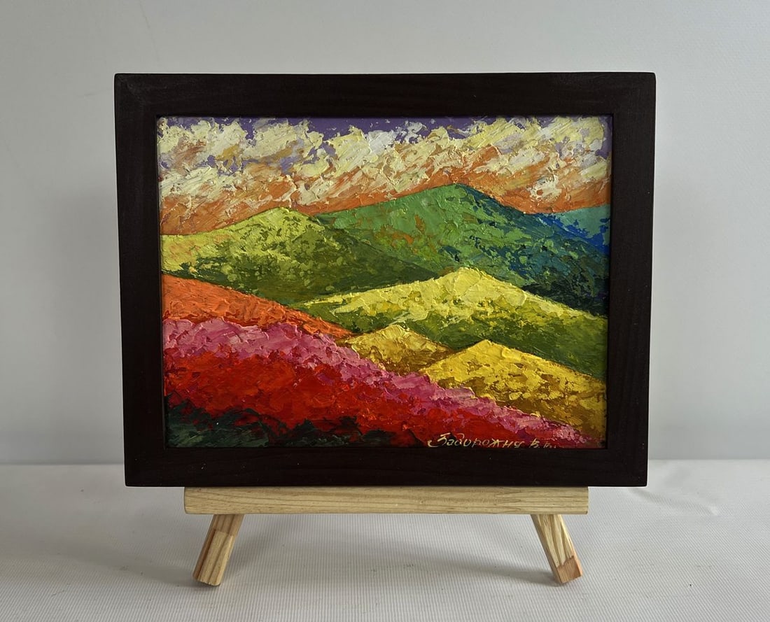 Oil painting Sunset on the top of the mountain V. Zadorozhnya: NoAAA4618The oil painting on cardboard titled "Sunset on the Top of the Mountain" is a vivid and expressive landscape that captures the grandeur of nature as it is bathed in the warm, golden hues of t
