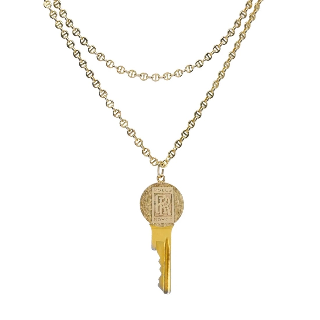 Vintage Cartier 14k Gold Rolls-Royce Key Pendant Necklace: Designer: Cartier Materials: 14k Gold Weight: Pendant - 11.6 Grams, Chain - 16.2 Grams Measurement: Pendant - 2" x 13/16", Chain - 24" Hallmarks: Cartier, 14K, Serial NumberITEM DETAILS:Vintage Cartie