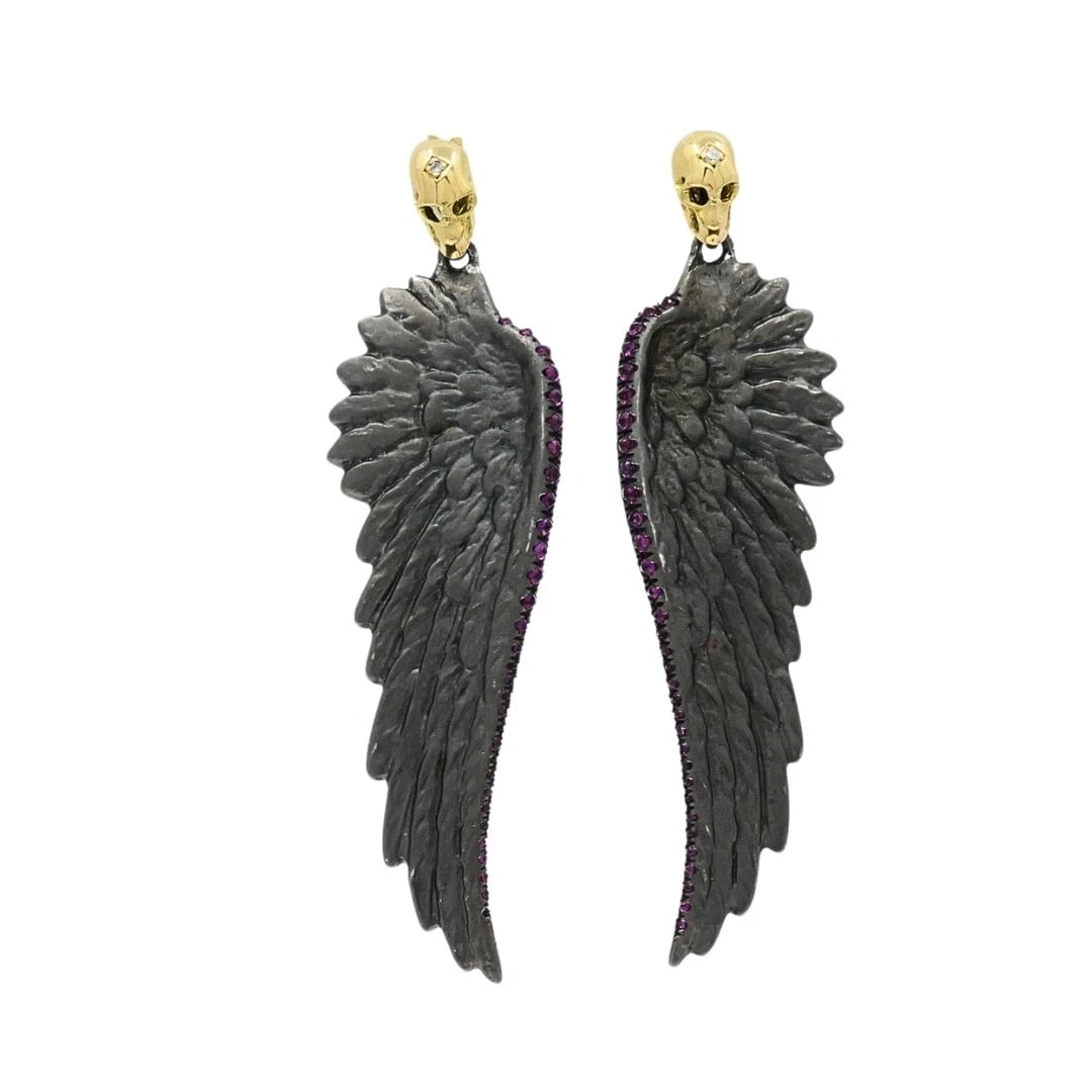 Theodoros 18k Gold & Sterling Silver Ruby Wing Skull Earrings: Designer: Theodoros Materials: 18k Gold, 925 Sterling Silver Gemstone: Ruby, Diamond Weight: 11.9 Grams Measurement: 1/2" x 2 1/8" Hallmarks: Theodoros, 925, 750ITEM DETAILS:Theodoros 18k Gold &