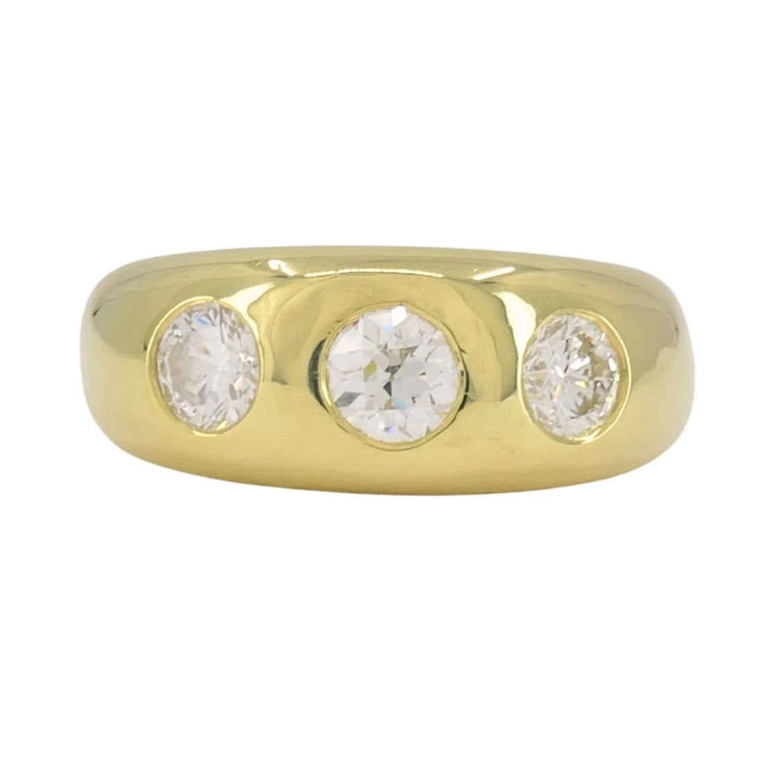 Vintage 18k Yellow Gold Three Stone Diamond Gypsy Ring: KL TOOO This vintage 18k yellow gold three stone diamond ring reflects the traditional gypsy ring style, known for its solid construction and flush set stones. Crafted in a smooth, rounded form, the b