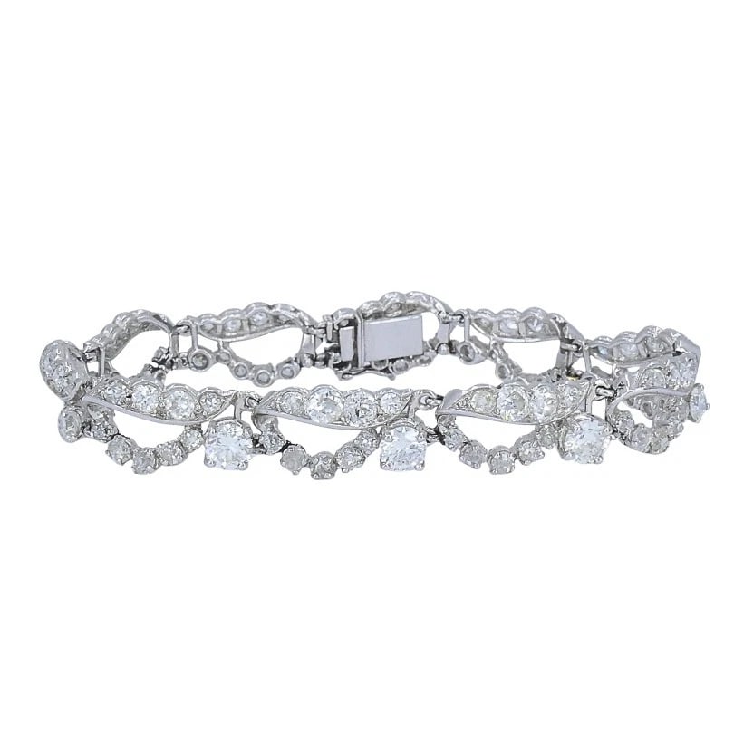 French Platinum Diamond Openwork Diamond Bracelet, 1960s: MATERIALS: Platinum GEMSTONE: Diamond WEIGHT: 25.7 Grams MEASUREMENTS: 6 1/2" x 3/8" HALLMARKS: Maker's MarkITEM DETAILS:Art Deco Platinum Diamond BraceletThis French platinum diamond bracelet showcas