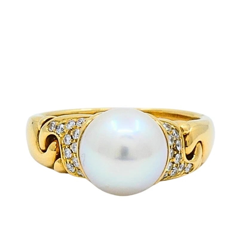 Bvlgari Pearl Diamond 18k Gold Cocktail Ring: DESIGNER: Bvlgari CIRCA: 1990's MATERIALS: 18k GoldGEMSTONE: Pearl, DiamondWEIGHT: 7.3 Grams RING SIZE: 6.75 - 7HALLMARKS: BVLGARI, 750ITEM DETAILS:Bvlgari Pearl Diamond 18k Gold Cocktail Ring This