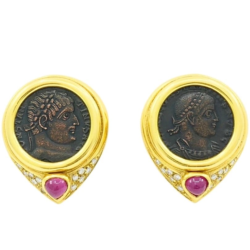 Ancient Coin 18k Gold Earrings Ruby: DESIGNER: Unknown CIRCA: 1980's MATERIALS: 18k Yellow Gold, SilverGEMSTONE: Ruby & DiamondWEIGHT: 33.4 GramsMEASUREMENTS: Diameter - 7/8 " Length - 1 1/16"HALLMARKS: 18K, 750ITEM DETAILS:Ancient Coin 