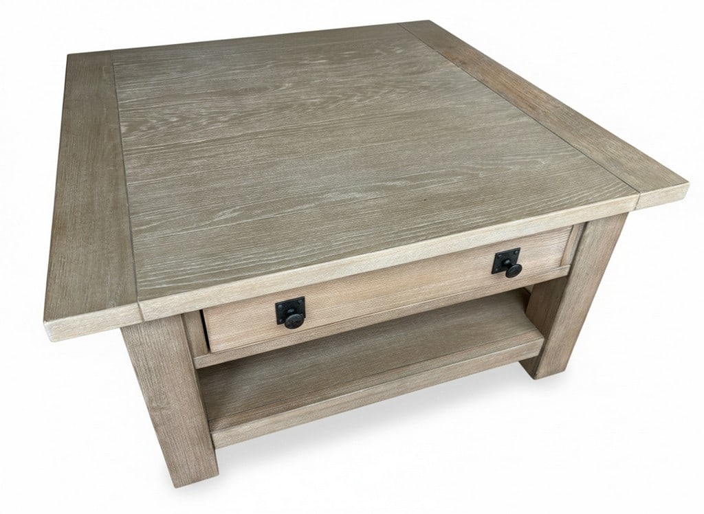 Contemporary Light Oak Finish Coffee Table with Drawer and Shelf: Contemporary coffee table featuring a light oak finish, a single storage drawer with dark metal pulls, and an open lower shelf for additional storage or display. The design is clean and transitional,