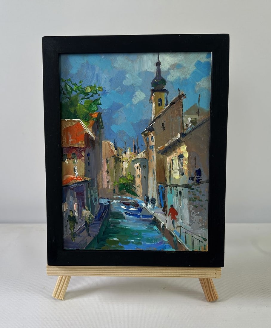 Oil painting History of the city street Yuriy Suprunchuk: NoAAA5511The Oil painting on Cardboard titled "History of the city street" is an evocative portrayal of an old European town, where time seems to flow like the canals that wind between its historic