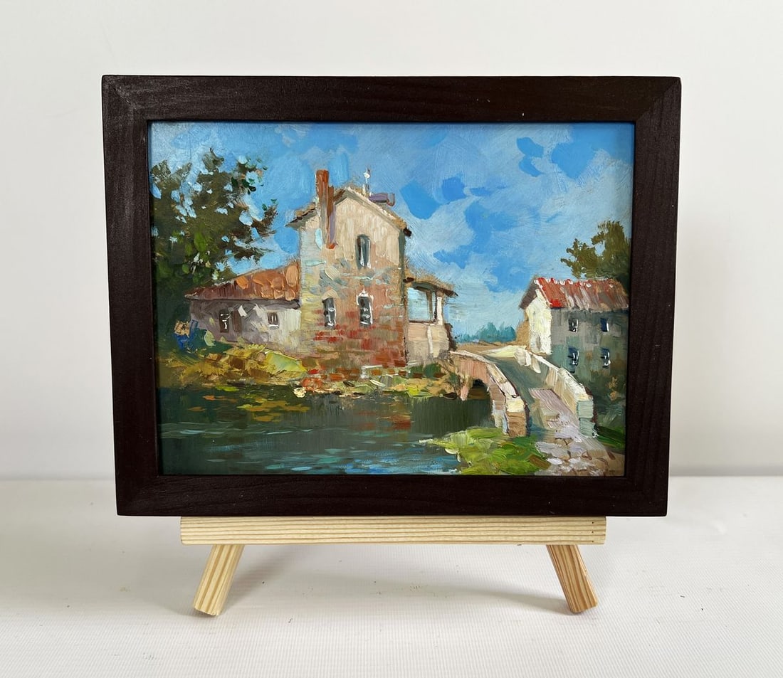 Oil painting The bridge leading to the city Yuriy Suprunchuk: NoAAA4431The painting "The Bridge Leading to the City" presents a picturesque scene of a small European-style village or town, where history and tranquility merge seamlessly. The composition is center