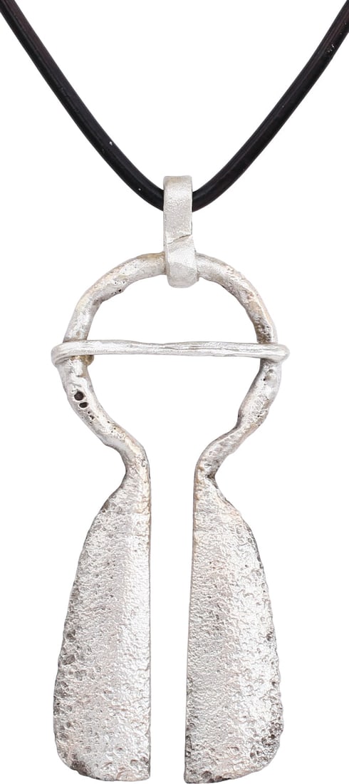 FINE VIKING PROTECTIVE BROOCH 900-1050 AD: Gilt bronze with round top, over 7/8” diameter with the cross pin. 2 1/8” height plus the loop. The terminals flared to long broad medially ridged tails. When fastened to the jerkin, these