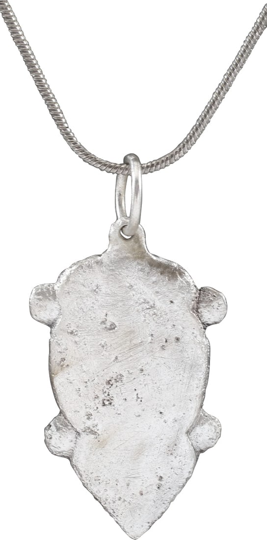VIKING HEART PENDANT NECKLACE, 10th-11th CENTURY AD: Complex heart form with rounded top formed by the scalloped sides. Elongated heart form, waisted or dimpled by four nubs describing a saltire. Domed form with deep relief cavity back, made by the