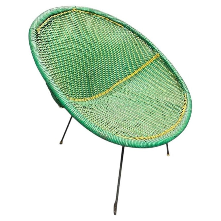 MCM Sam Avedon Styled Iron Outdoor/Patio Saucer Chair w/ Nylon Weaved Seat: This mid-century outdoor chair, styled after Sam Avedons designs, features a vibrant green woven nylon seat with bold yellow accents, creating a striking contrast. The iron saucer-shaped design